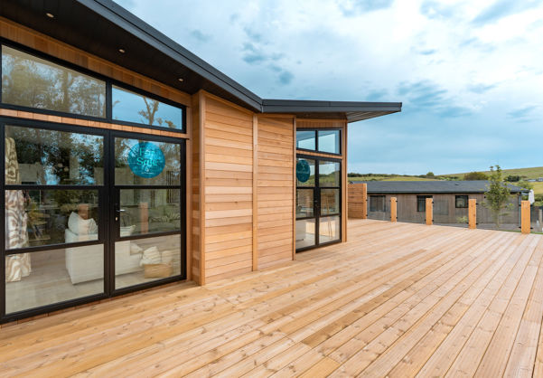 External of a luxury lodge on pitch with extensive decking