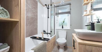 Internal of a lodge bathroom with shower over bath
