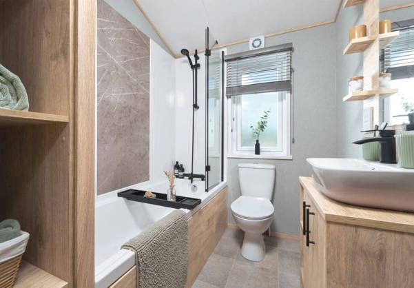 Internal of a lodge bathroom with shower over bath