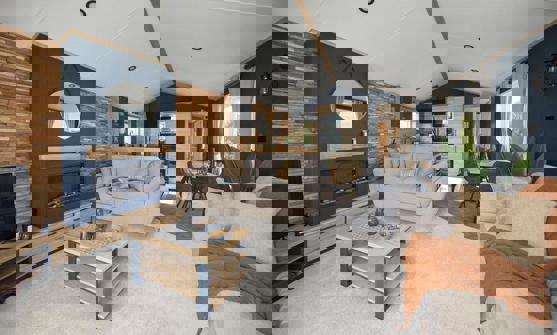 Modern lounge with comfy sofas, fireplace, natural wood, faux brick walls and dark blue walls design