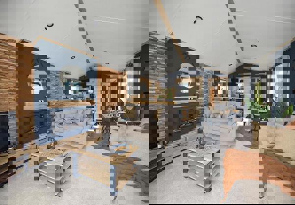 Modern lounge with comfy sofas, fireplace, natural wood, faux brick walls and dark blue walls design