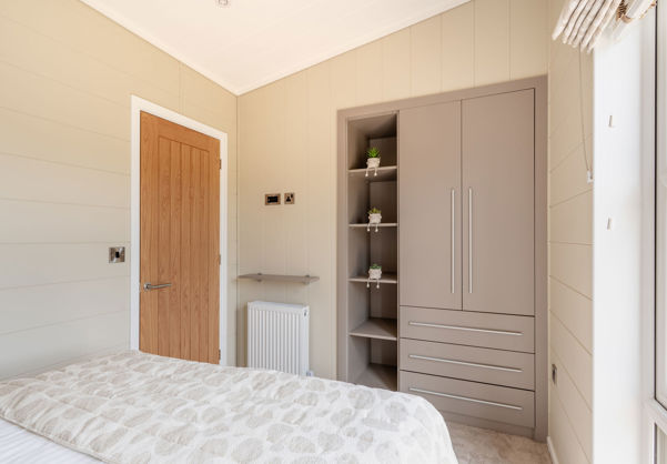 Internal of a luxury lodge double bedroom with storage area