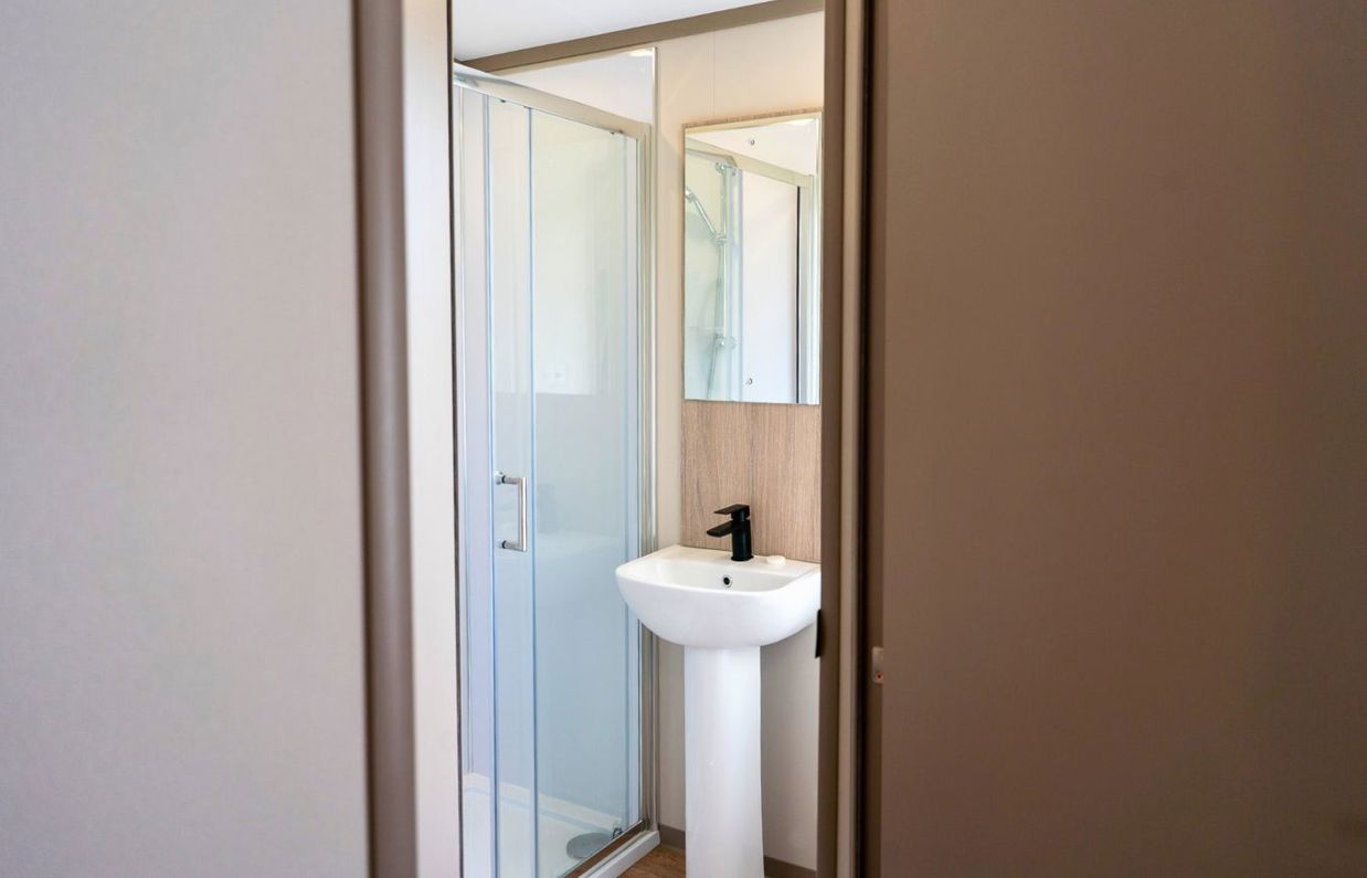 Internal of a caravan bathroom with shower and sink