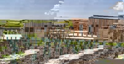 Exterior of a Super Lodge surrounded by Wildflowers and Rolling Hills