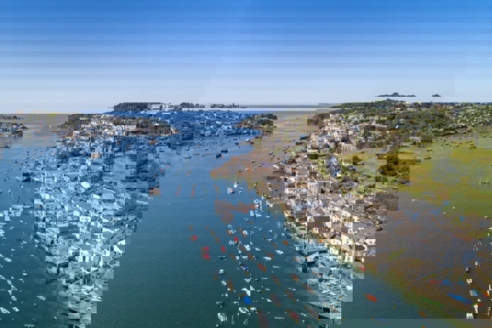 Fowey town and harbour from above with blue waters out to sea