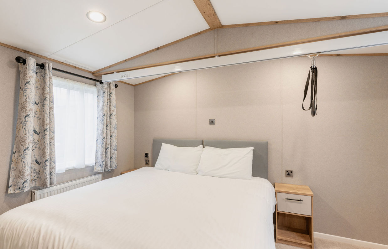 Internal of an accessible caravan double bedroom with hoist