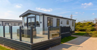 External of a lodge with decking, outdoor furniture, and driveway