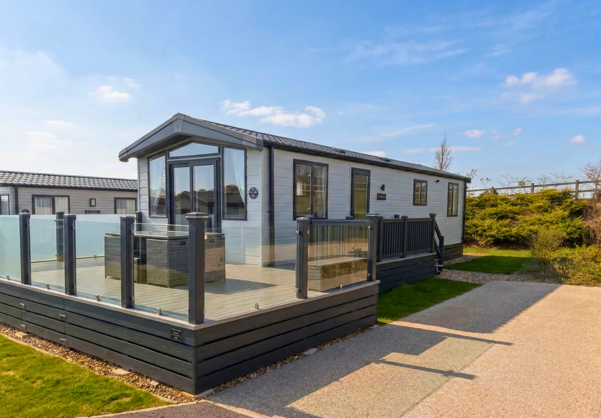 External of a lodge with decking, outdoor furniture, and driveway