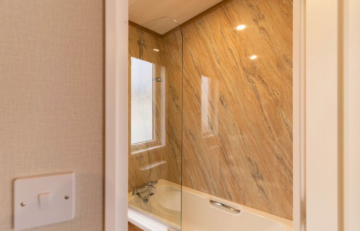 Internal of a caravan bathroom with shower over bath