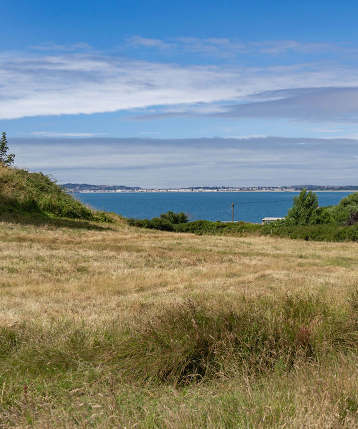 View across field to Weymouth from Osmington Mills Lodge Park