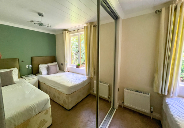 Internal of a lodge twin bedroom with storage
