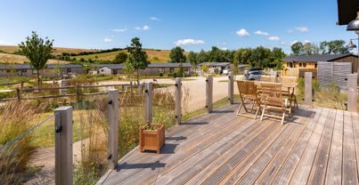 External of a cabin with decking and outdoor furniture