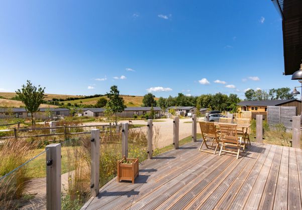External of a cabin with decking and outdoor furniture