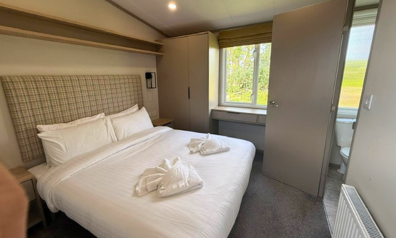 Internal of a caravan master bedroom with ensuite