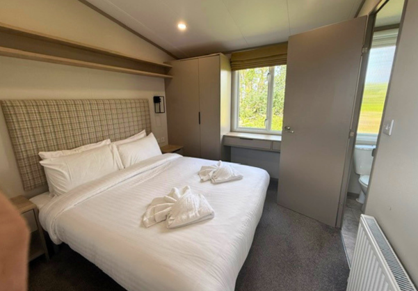 Internal of a caravan master bedroom with ensuite