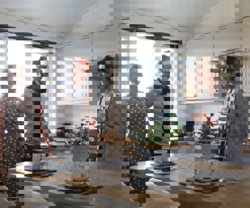 A couple being shown around a holiday home by a sales team member