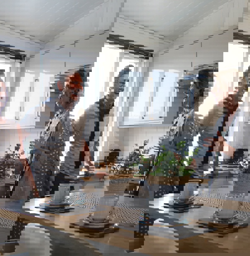 A couple being shown around a holiday home by a sales team member