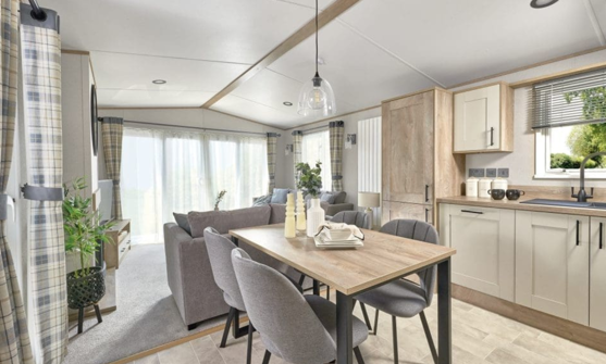 Internal of a caravan kitchen with freestanding dining table
