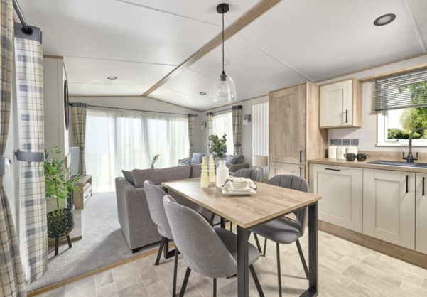 Internal of a caravan kitchen with freestanding dining table