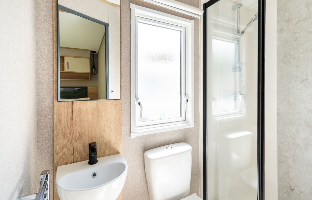 Internal of a caravan bathroom with shower, toilet and sink