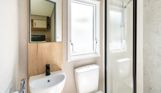 Internal of a caravan bathroom with shower, toilet and sink