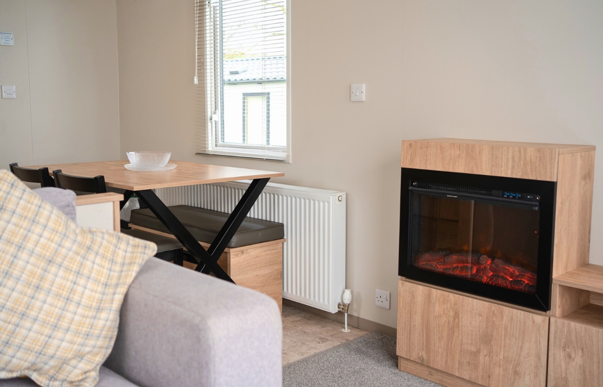 Internal of a caravan open plan living space with electric fire