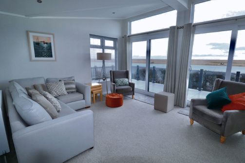 Internal of a caravan open plan lounge with seaviews