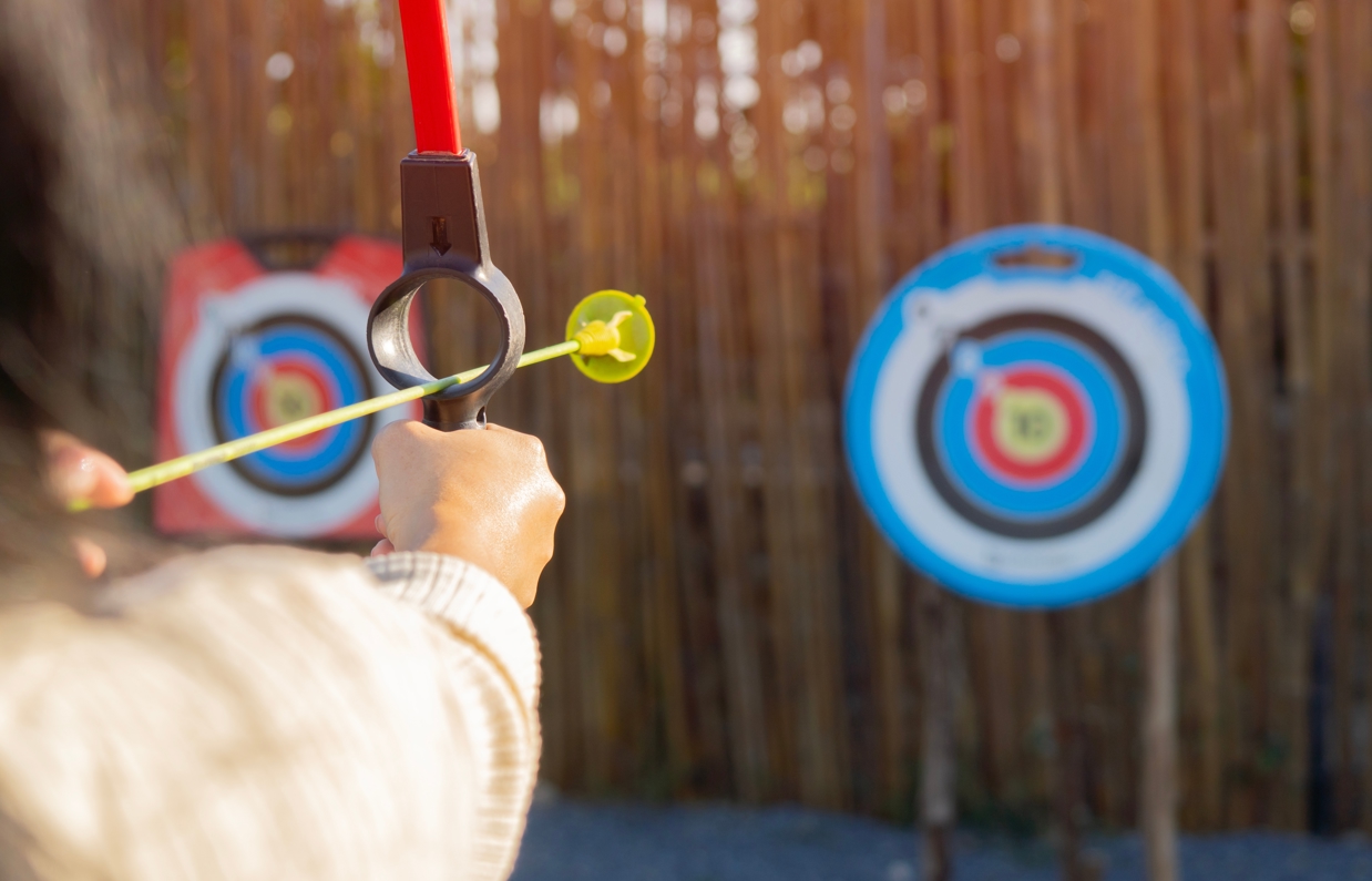 A soft archery bow aiming at a target
