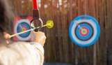 A soft archery bow aiming at a target