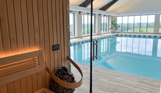 Sauna and indoor swimming pool within a barn style building
