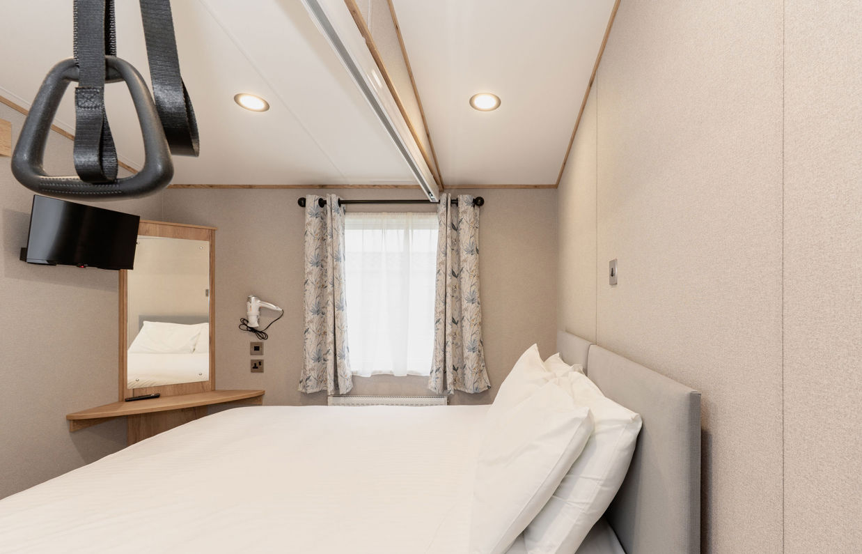Internal of an accessible caravan double bedroom with hoist