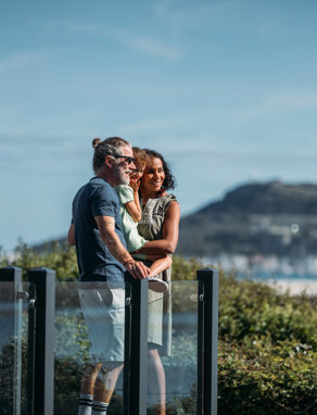 Family admiring the view from the deck of their holiday home