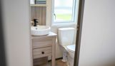 Internal of a caravan bathroom with toilet and sink