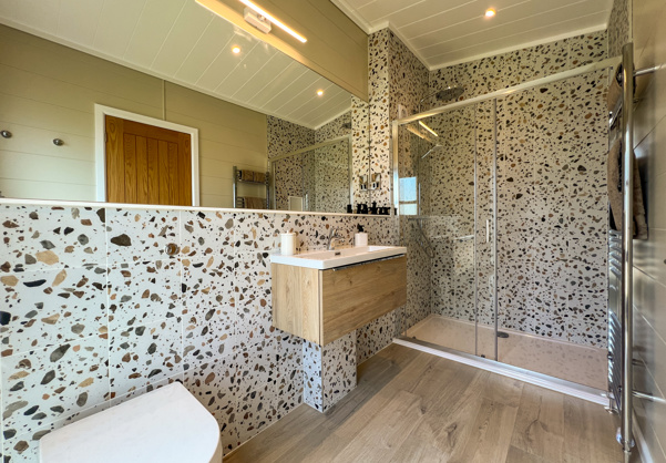 Internal of a luxury lodge ensuite bathroom with shower toilet and sink