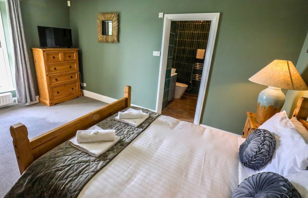 Internal of a manor house double bedroom with tv and ensuite