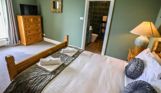Internal of a manor house double bedroom with tv and ensuite