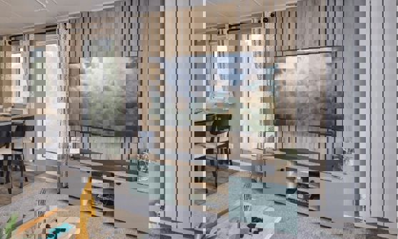 TV unit and storage cupboard against natural wood features