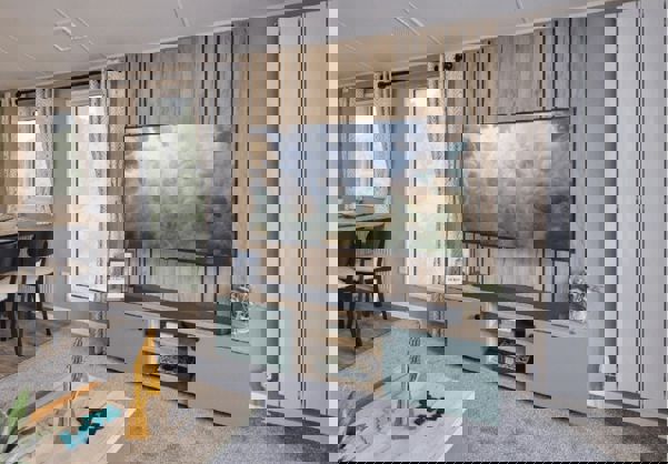 TV unit and storage cupboard against natural wood features