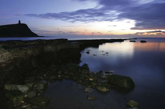 The coast at sunset with shallow waters and rockpools