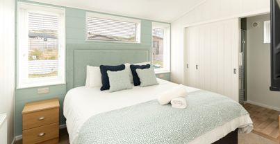 Internal of a luxury lodge master bedroom with ensuite and storage