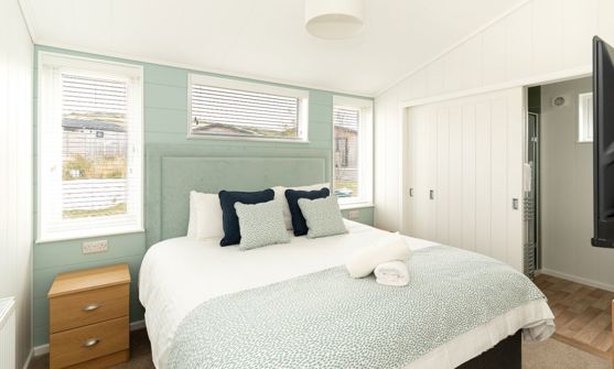 Internal of a luxury lodge master bedroom with ensuite and storage