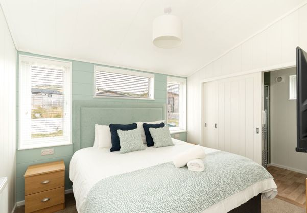 Internal of a luxury lodge master bedroom with ensuite and storage