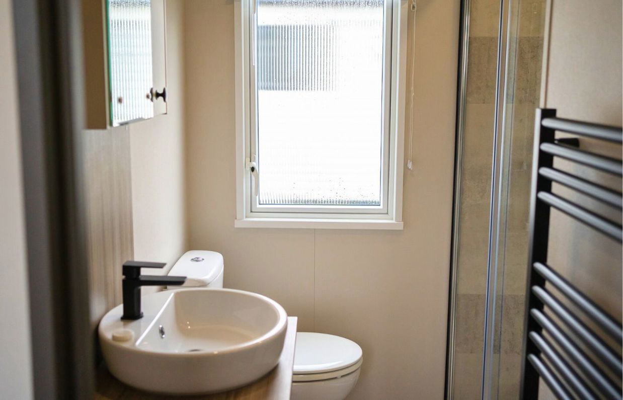 Internal of a caravan bathroom with shower, toilet and sink