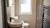 Internal of a caravan bathroom with shower, toilet and sink