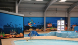 A children's splash zone within a heated indoor swimming pool complex