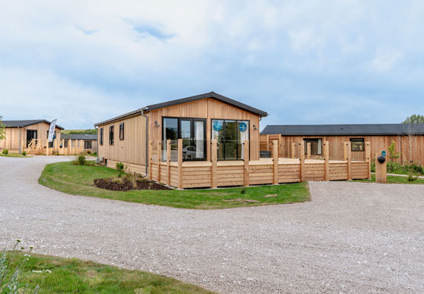 External of a luxury lodge on pitch with decking