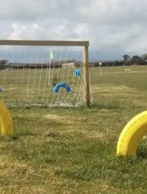 A football golf style obstacle course within a field
