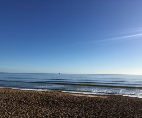 View of the Sea from Bowleaze Cove Beach on a Sunny Blue Day