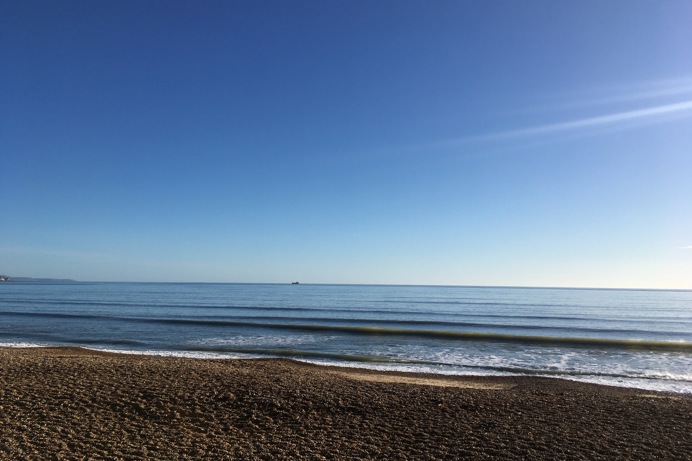 View of the Sea from Bowleaze Cove Beach on a Sunny Blue Day