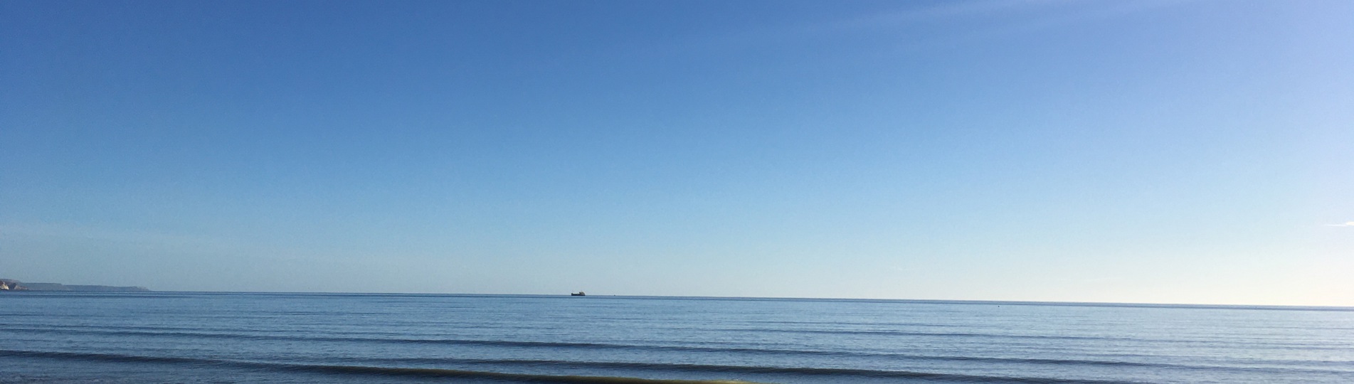View of the Sea from Bowleaze Cove Beach on a Sunny Blue Day